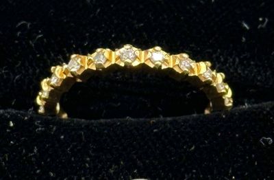 yellow gold wedding ring with diamonds on velvet display case