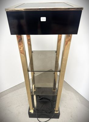an image of a black and gold display case with a glass shelf