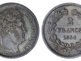 a silver coin with an image of a woman on it