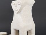an image of a white ceramic sculpture with a face on it