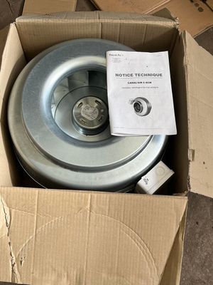 a box with a wheel inside of it on the floor