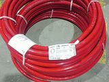 a red hose that is sitting on the floor