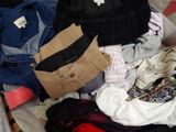 a suitcase full of clothes and a handbag sitting on a bed