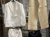 three pieces of clothing hanging on a rack in a room