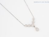 a close up of a necklace with a cross on it