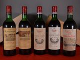 several bottles of wine are lined up on a red table