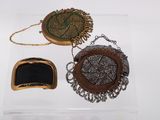 two small purses and a small purse on a clear box