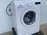 an image of a washing machine sitting on top of a pallet