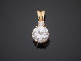 a diamond pendant on a black surface