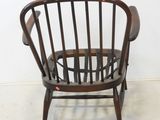 a wooden chair that is sitting in a room