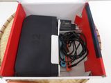 a box with a laptop and a charger inside of it