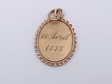 a close up of a gold medal with the date on it