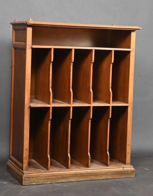 an old wooden bookcase with many shelves on it