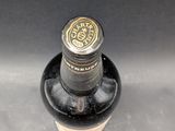 a black bottle with a brown label on it