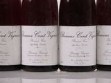 four bottles of wine are lined up on a table