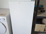 a microwave sitting on top of a refrigerator next to a washing machine