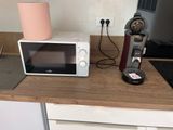 a microwave and a coffee maker on a kitchen counter