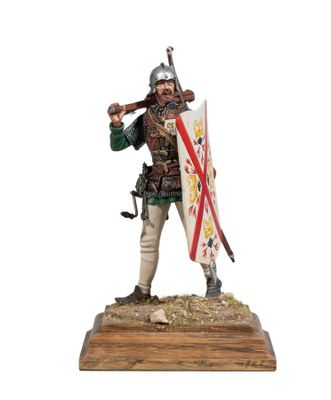 the figurine is holding a sword and shield on a wooden base