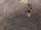 a close up view of a piece of metal with a hole in it