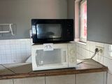 a microwave sitting on top of a counter in a kitchen