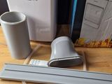 a small air conditioner sitting on a table next to a cup of coffee