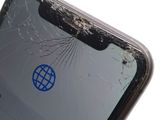 a broken cell phone with a blue sticker on the screen