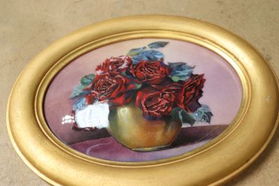 une photo d'un tableau représentant des roses dans un vase doré