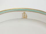an image of a white plate with gold trim and a cat on it