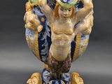 a blue and white vase with a man on it