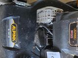 a black and yellow corded machine on the floor