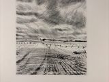 a black and white photo of a book with a sky in the background