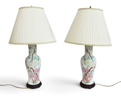pair of chinese style lamps with a white shade and a floral pattern on the base