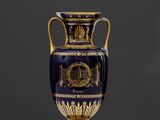 une image représentant un vase bleu et doré posé sur une table