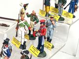 many figurines of soldiers on display in a display case