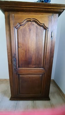 a wooden cabinet with a mirror on top of it