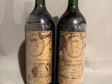 two bottles of wine sitting next to each other on a table
