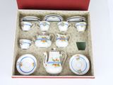 a box that has a set of tea cups and saucers in it
