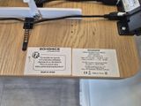 a wooden table with a laptop and a charger on top of it