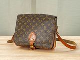 an image of a louis vuitton cross body bag on a table