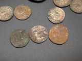 some old coins are sitting on a table with a black background