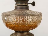 a glass lamp that is on top of a table