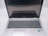 an open laptop computer sitting on top of a white table