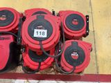 several red and black fire hydrant sitting on top of a sidewalk