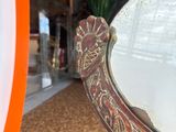 a mirror that is sitting on the floor in front of a surfboard
