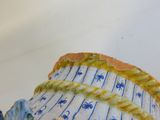 a blue and white vase that has a fish on it