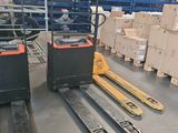 forklifts and pallets in a warehouse with boxes on the floor