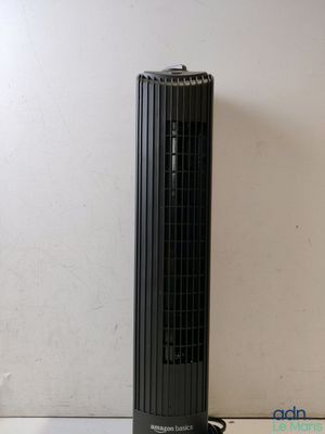 a black tower fan sitting on a table next to a white wall