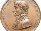 an image of a bronze medal with a portrait of a man on it