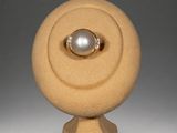 an image of a gold ring with a pearl on top of it
