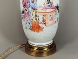 a white vase with a painting on it sitting on a table